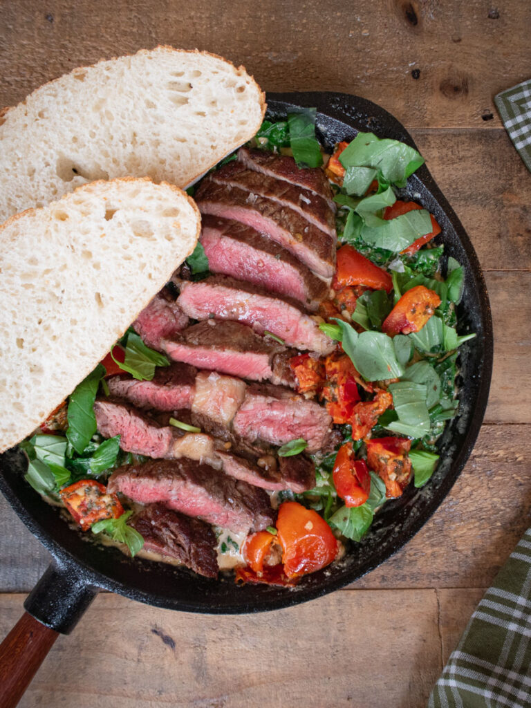 Grilled steak with creamed kale and dried tomato