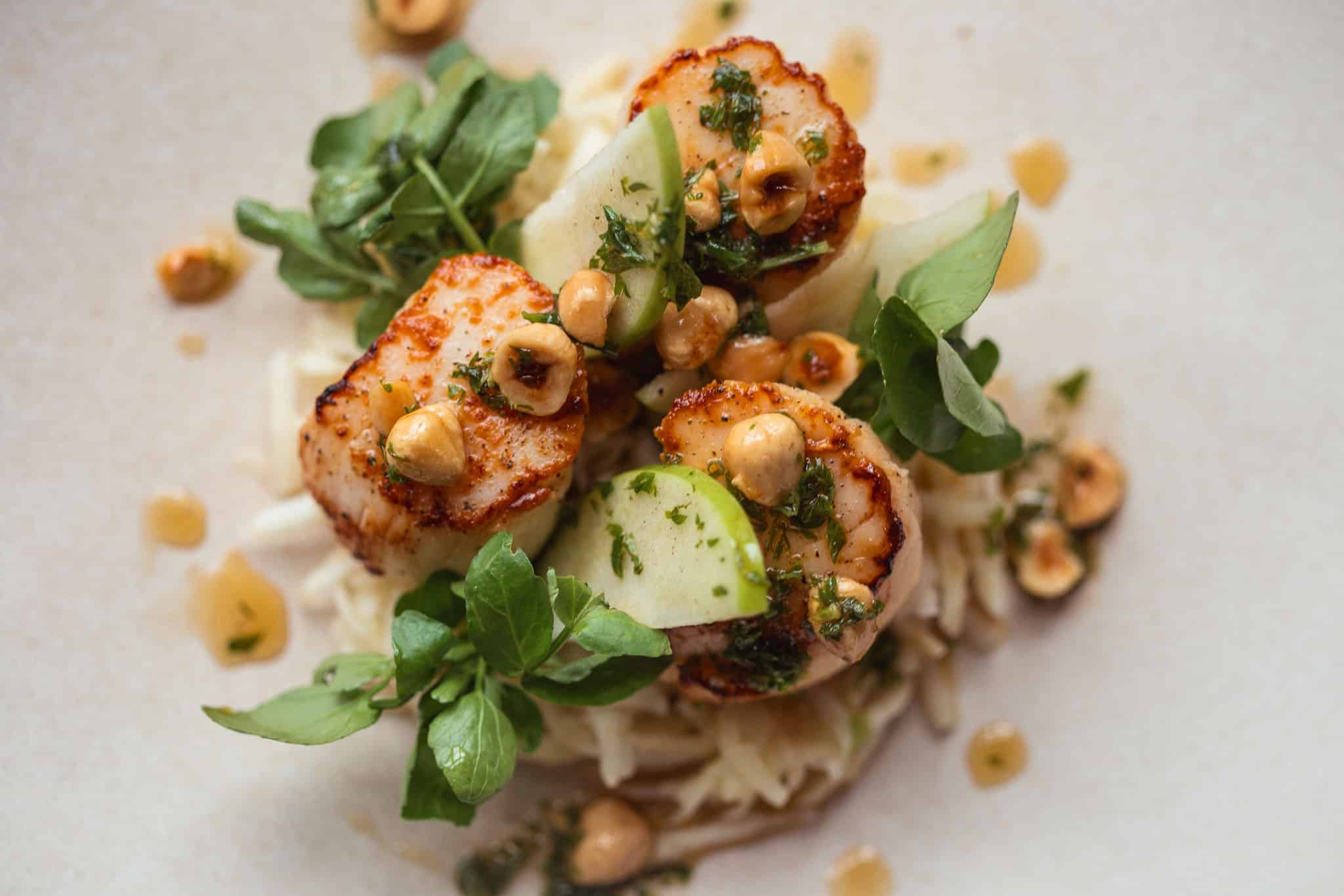 Seared scallops with a celeriac and apple salad, watercress, hazelnut and brown butter vinaigrette